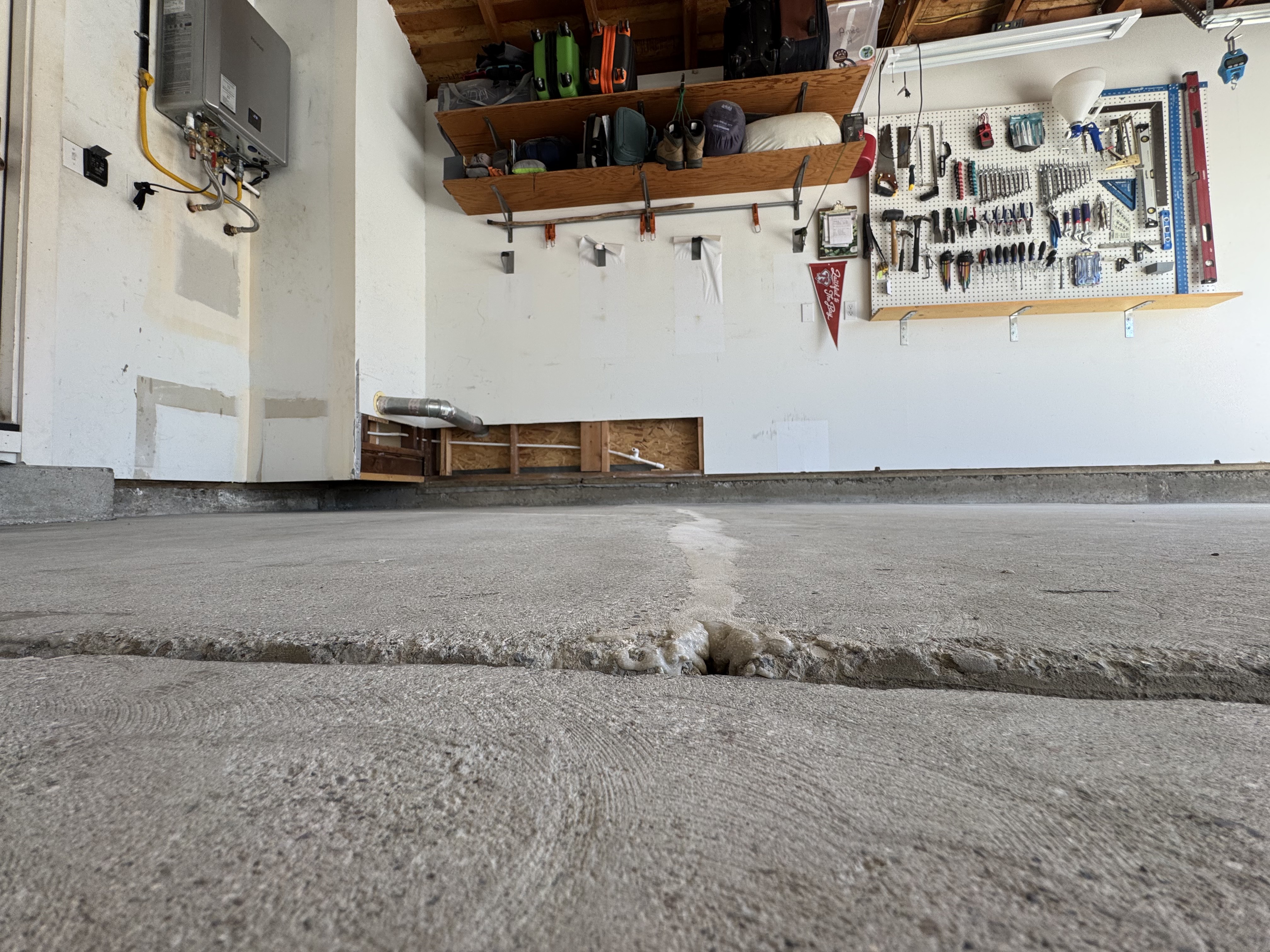 Cracked concrete garage floor before coating