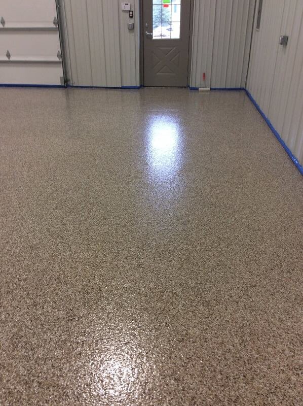 Glossy flake polyaspartic floor finish by garage door